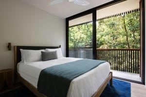 a bedroom with a bed and a large window at Moonrise in Byron Bay