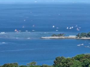 an island with boats in the water with sailboats at Villa Umbrella Lombok in Senggigi 