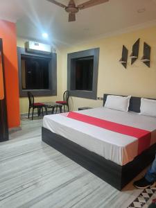a bedroom with a large bed in a room at VENTURE INN in Bhubaneshwar