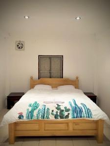 a bedroom with a wooden bed with a blanket on it at Mary’s Home Stay in Luang Prabang