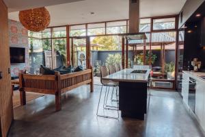 a kitchen with a bench and a table in a room at Sticky Rice Villas in Stirling