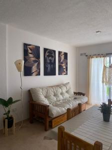 a living room with a couch and a table at Cielo in Concepción del Uruguay