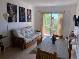 a living room with a couch and a table at Cielo in Concepción del Uruguay +10 photos