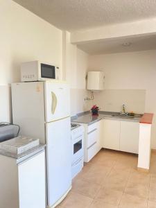 a kitchen with white appliances and a white refrigerator at Cielo in Concepción del Uruguay