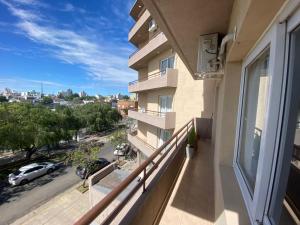 an apartment balcony with a view of a street at Cielo in Concepción del Uruguay