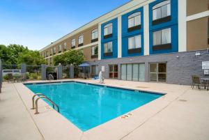 a swimming pool in front of a building at Holiday Inn Express & Suites - Mobile - I-65, an IHG Hotel in Mobile