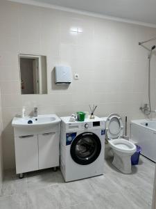 bagno con lavatrice e servizi igienici di Platinum apartment a Bishkek