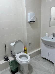La salle de bains est pourvue de toilettes et d'un lavabo. dans l'établissement Platinum apartment, à Bishkek