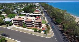 an overhead view of a street with a building and the ocean at Alexander Beachfront Apartments in Hervey Bay