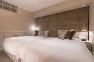 Un pat sau paturi într-o cameră la Y11 hotel azabu ten