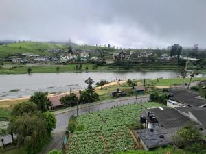 a view of a river with a town in the background at Creek View Inn in Nuwara Eliya