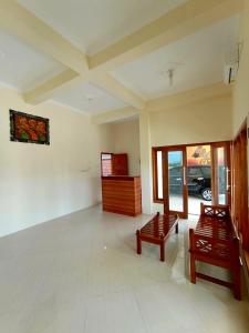 a living room with two benches and a room with a car at Kresna Guest House Syariah Pacitan in Pacitan +27 photos