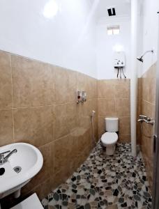 a bathroom with a sink and a toilet at Kresna Guest House Syariah Pacitan in Pacitan +27 photos