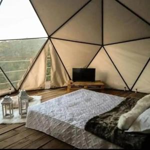 a room with a bed in a tent at Glamping San Luis in San Luis