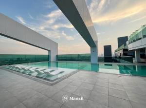 a swimming pool on the roof of a building at Manzil - 2BR Apt in Al Wasl Residences with Park View, Dubai Trade Center in Dubai