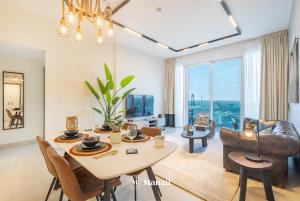 a dining room and living room with a table and chairs at Manzil - 2BR Apt in Al Wasl Residences with Park View, Dubai Trade Center in Dubai