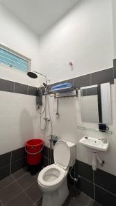 a bathroom with a toilet and a sink at Asmar's Homestay Alor Setar in Alor Setar