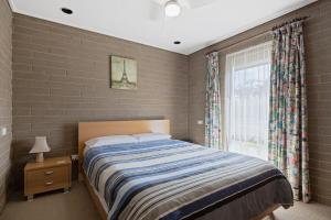 a bedroom with a large bed and a window at 21 Shamrock Avenue Cowes in Cowes