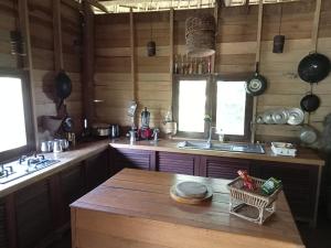 a kitchen with wooden counters and a wooden table at Fandee Island - Secret Private House - Tad Lo Bolaven Loop Pakse in Ban Kiangtat
