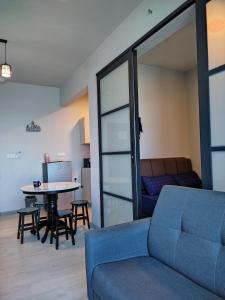 a living room with a couch and a table at JQ ArasTwo Homestaykk LEVEL 22 SEAVIEW in Kota Kinabalu