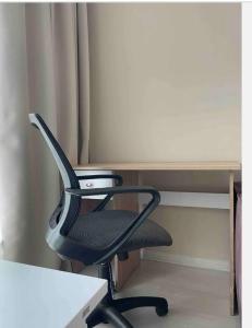 a black office chair sitting in front of a desk at Mira Apart-Hotel in Kyiv