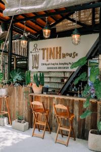 a couple of chairs sitting in front of a counter at TỊNH House Phú Quốc in Phu Quoc