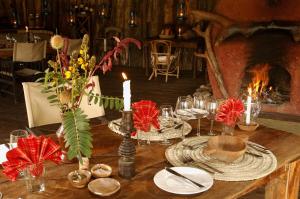 a table with candles and flowers on top of it at Crater Forest Tented Lodge in Karatu