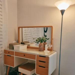 a desk with a mirror and a lamp on it at J-Stay near Hongdae in Seoul