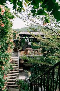 a stairway leading up to a house with a garden at TỊNH Retreat Phu Quoc in Phú Quốc