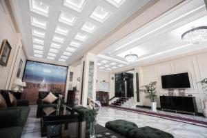 a living room with a ceiling with skylights at Hotel Arhan Palace in Samarkand