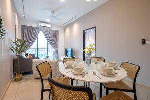 a dining room with a white table and chairs at Blissful Cottage@FeelHome/2BR,7pax,MRT 中文房东 in Kuala Lumpur
