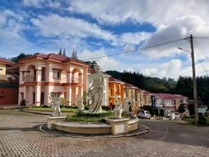 a fountain in the middle of a street in a town at Manyak Villa at Berastagi Resort C14 Jl Mimpin Tua in Berastagi