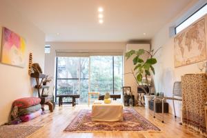 a living room with a table and a large window at gesthouse better half in Kamakura