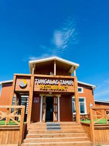 a building with a sign for a turkey tank restaurant at Tungalag tamir tourist camp 