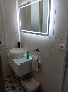 a white bathroom with a sink and a mirror at TraviesaBetanzos in Betanzos