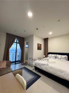 a bedroom with a large bed and a couch at The Shore Kota Kinabalu by Ariana in Kota Kinabalu