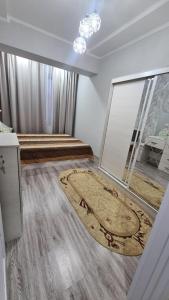 a room with a large rug on the floor at Квартира в новом жилом комплексе Invest House in Tashkent