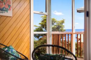 a view of the ocean from the porch of a house at Stunning Ocean View Perfect For Groups & Families in Cooee