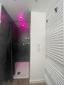 y baño con ducha con luces rosas. en GRYT Home - FeWo XXL - Nähe Nordsee, en Ramhusen