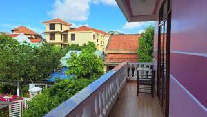 a balcony with a view of a city at Pink house Homestay in Hoi An