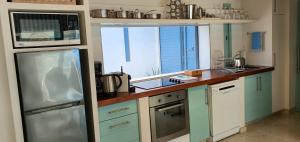 a kitchen with blue cabinets and a counter top at Penguin's Nest in Paternoster +11 photos