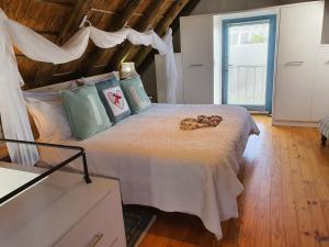 a bedroom with a large bed with a wooden ceiling at Penguin's Nest in Paternoster