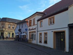 a group of buildings on a cobblestone street at Alte Schmiede Buckow in Buckow