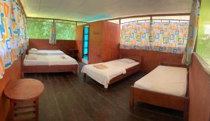 En eller flere senge i et værelse på Ayahuasca Eco Tours