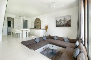 un soggiorno con divano e una cucina di Sore Pererenan Residence Unit 1 a Canggu