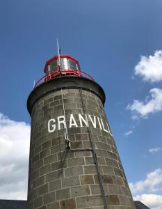 a brick lighthouse with the words grandma written on it at Haute ville : studio ravissant in Granville