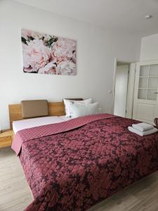 a bedroom with a large bed with a purple blanket at Heine`s Hof in Oschersleben