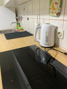 a white toaster sitting on a counter in a kitchen at STUDIO APP STELLA Dnevni najam stana Jarun Zagreb in Zagreb