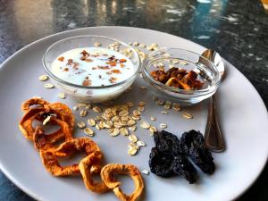 a plate of food with pretzels and a bowl of cereal at Hinkerhof in Schladming