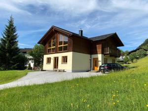 a house with a car parked in front of it at Skiblickhaus in Russbach am Pass Gschütt